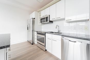 Kitchen with tile backsplash and granite countertops 